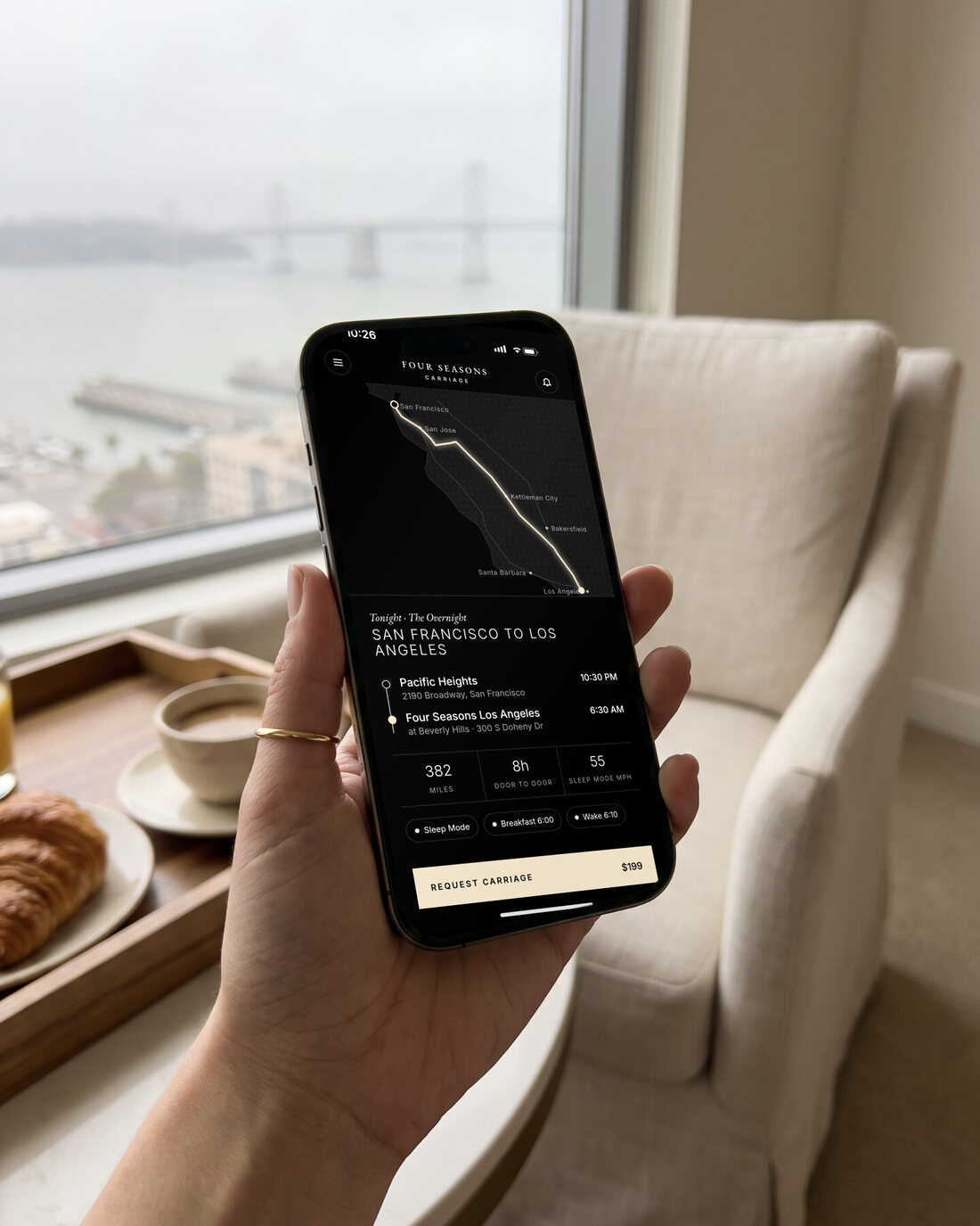 A hand holding an iPhone showing the app: plan