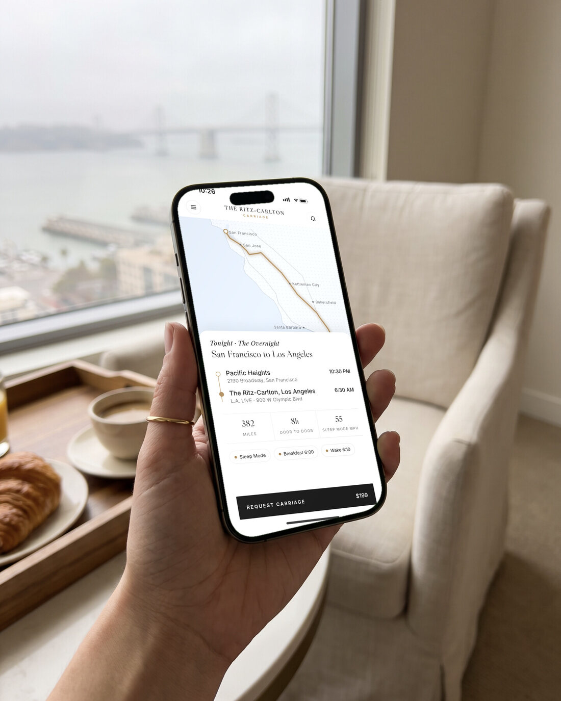 A hand holding an iPhone showing the app: plan